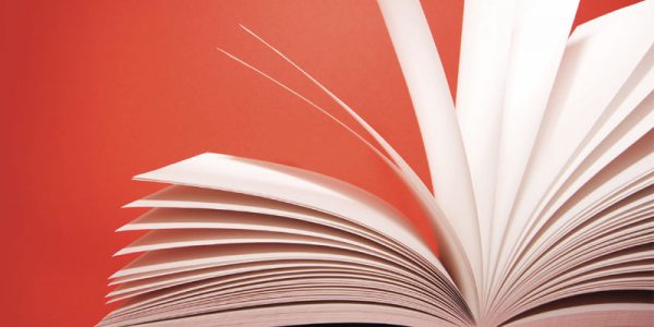 Open pages of a book against a red background