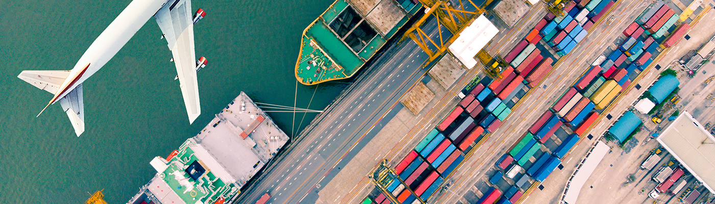 Aerial view of container cargo ship and cargo plane with working crane bridge in shipyard